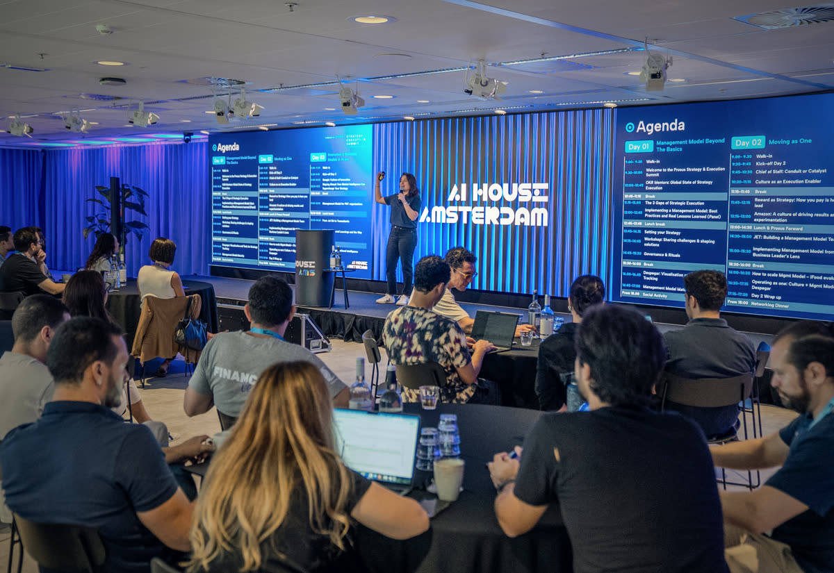 Corporate conference: speaker on stage with LED screens and audience